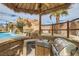 Covered outdoor kitchen with built-in grill and sink, perfect for poolside entertaining and dining at 3892 Pasilla Ave, Las Vegas, NV 89118