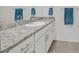 Bathroom featuring double sinks, granite countertops, and chrome fixtures at 392 Canary Song Dr, Henderson, NV 89011