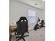 Spare bedroom with a computer chair and desk near a stationary bike at 392 Canary Song Dr, Henderson, NV 89011