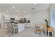 Bright kitchen with white cabinets, stainless steel appliances, granite countertops, and a breakfast bar at 392 Canary Song Dr, Henderson, NV 89011