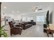 Spacious living room features tile floors, recessed lighting, and is adjacent to the kitchen and dining area at 392 Canary Song Dr, Henderson, NV 89011