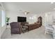 Comfortable living room with tile floors, features a large television and an open floor plan at 392 Canary Song Dr, Henderson, NV 89011