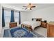 Comfortable main bedroom with carpet, ceiling fan, and large window with curtains at 392 Canary Song Dr, Henderson, NV 89011