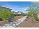 Community playground with swingset, walking path, bench, and desert landscaping at 392 Canary Song Dr, Henderson, NV 89011