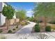 Community walkway featuring desert landscaping including trees, shrubs, and gravel at 392 Canary Song Dr, Henderson, NV 89011