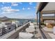 A modern balcony with patio furniture and lake view connects to bedroom through sliding glass doors at 40 Heron Harbour Dr, Henderson, NV 89011