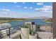 A modern balcony with lake view framed by black metal railing and decorated with large potted plants at 40 Heron Harbour Dr, Henderson, NV 89011