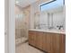 Modern bathroom with glass-enclosed shower, floating vanity, and large mirror at 40 Heron Harbour Dr, Henderson, NV 89011