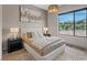 Stylish bedroom with a modern bed, artwork, and large window offering mountain views at 40 Heron Harbour Dr, Henderson, NV 89011