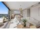 Bright main bedroom features a seating area, balcony access, and lake views at 40 Heron Harbour Dr, Henderson, NV 89011