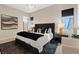 Elegant bedroom with a dark bed frame, accent pillows, and modern decor at 40 Heron Harbour Dr, Henderson, NV 89011