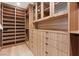 Spacious walk-in closet includes custom shelves, drawers, and glass-front cabinets at 40 Heron Harbour Dr, Henderson, NV 89011