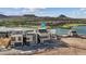 Modern two-story home with a two-car garage overlooking a lake, golf course, and mountain views at 40 Heron Harbour Dr, Henderson, NV 89011