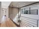 Bright hallway with modern railing, hardwood floors, and contemporary lighting fixtures at 40 Heron Harbour Dr, Henderson, NV 89011