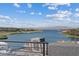 A scenic lake view featuring waterfront properties and rolling hills under a blue, cloud-filled sky at 40 Heron Harbour Dr, Henderson, NV 89011