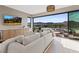 Living room includes modern furniture, balcony access, and views of the water at 40 Heron Harbour Dr, Henderson, NV 89011