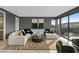 Spacious living room with a large sectional sofa, stylish rug, and expansive windows at 40 Heron Harbour Dr, Henderson, NV 89011