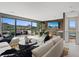 Open-concept living room with modern furniture, a dining area, and a large sliding glass door with mountain views at 40 Heron Harbour Dr, Henderson, NV 89011