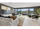 Open concept living room with large windows and sliding doors, mountain view and dining area with seating at 40 Heron Harbour Dr, Henderson, NV 89011