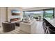 Spacious living room with a fireplace, stylish furniture, and panoramic mountain views through large windows at 40 Heron Harbour Dr, Henderson, NV 89011