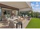 Inviting outdoor living space with a fireplace, comfortable seating, and views of the open interior of the house at 40 Heron Harbour Dr, Henderson, NV 89011