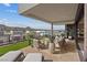 Inviting outdoor patio with a fire pit, plush seating, and beautiful views of the lake and hillside at 40 Heron Harbour Dr, Henderson, NV 89011