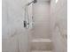 Close-up of a marble tiled shower with a built-in seat and sleek fixtures at 40 Heron Harbour Dr, Henderson, NV 89011