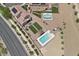 Overhead view of backyard featuring a pool, artificial turf, landscaping, and a neighboring home with a pool at 4030 Midnight Crest Ave, North Las Vegas, NV 89031