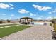 A spacious backyard with a gazebo, seating, and artificial grass at 4030 Midnight Crest Ave, North Las Vegas, NV 89031