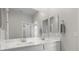 Bright bathroom features a double sink vanity with white cabinets and multiple mirrors at 4030 Midnight Crest Ave, North Las Vegas, NV 89031