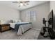 Neutral bedroom with a large window, ceiling fan, and side table at 4030 Midnight Crest Ave, North Las Vegas, NV 89031