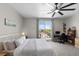 Inviting bedroom with a ceiling fan and a balcony overlooking a community pool at 4030 Midnight Crest Ave, North Las Vegas, NV 89031