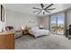 Bright bedroom featuring a ceiling fan and sliding glass doors leading to a private balcony at 4030 Midnight Crest Ave, North Las Vegas, NV 89031