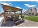 Backyard gazebo features comfortable seating on a paved patio and adjacent lawn at 4030 Midnight Crest Ave, North Las Vegas, NV 89031