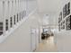 Bright hallway featuring a staircase and several framed pictures at 4030 Midnight Crest Ave, North Las Vegas, NV 89031