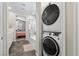 Modern laundry area with stacked washer and dryer, located near the bathroom at 4030 Midnight Crest Ave, North Las Vegas, NV 89031