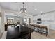 Open concept living room and kitchen featuring a dining area and barstool seating at 4030 Midnight Crest Ave, North Las Vegas, NV 89031