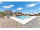 A refreshing in-ground pool is surrounded by seating and desert landscaping at 4030 Midnight Crest Ave, North Las Vegas, NV 89031