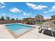 Large in-ground pool is surrounded by desert landscaping and a gazebo with lounge seating at 4030 Midnight Crest Ave, North Las Vegas, NV 89031