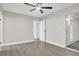 A spacious bedroom with wood-look flooring, ceiling fan, and access to a patio or balcony at 417 N Lamb Blvd # E, Las Vegas, NV 89110