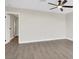 Spacious bedroom with wood-look floors, ceiling fan, and a freshly painted neutral color scheme at 417 N Lamb Blvd # E, Las Vegas, NV 89110