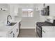 Modern kitchen featuring white cabinets, marble countertops, and stainless steel appliances at 417 N Lamb Blvd # E, Las Vegas, NV 89110