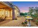 Beautiful backyard with a stone patio, a water fountain feature, and lush landscaping at 4286 Pacifico Ln, Las Vegas, NV 89135