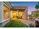 Inviting backyard with covered patio, outdoor seating, lush landscaping, and a glimpse of the home's interior at 4286 Pacifico Ln, Las Vegas, NV 89135