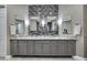 A bathroom featuring dual sinks and vanity with grey wood cabinetry at 4286 Pacifico Ln, Las Vegas, NV 89135