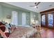 This bedroom features a sitting area, hardwood floors and a ceiling fan at 4286 Pacifico Ln, Las Vegas, NV 89135
