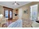 Spacious bedroom featuring hardwood floors, a ceiling fan, and arched double doors at 4286 Pacifico Ln, Las Vegas, NV 89135