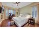 Inviting bedroom featuring a bay window, decorative curtains, and hardwood floors at 4286 Pacifico Ln, Las Vegas, NV 89135