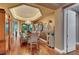 Elegant dining room with chandelier, glass table, and hardwood floors ideal for gatherings and entertaining at 4286 Pacifico Ln, Las Vegas, NV 89135