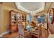 Beautiful dining area with glass table, chandelier, and hardwood floors perfect for formal entertaining at 4286 Pacifico Ln, Las Vegas, NV 89135